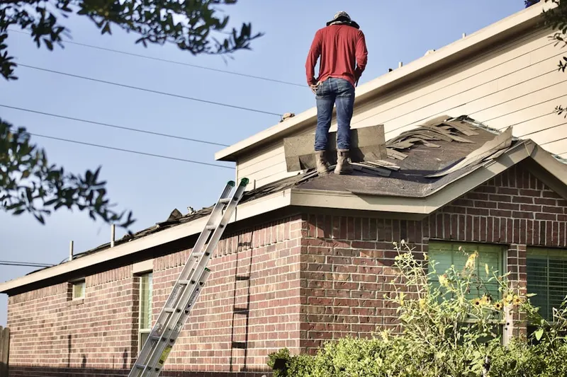 Professional roofer working on a residential roof in Bar Harbor